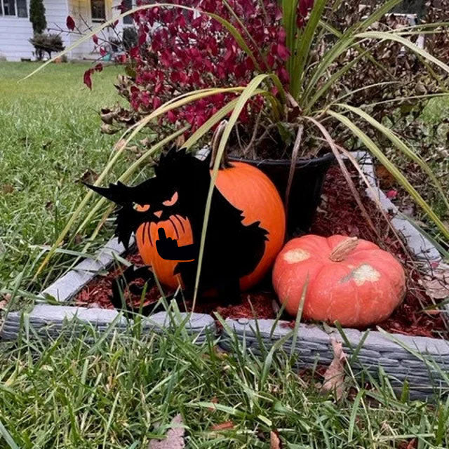 Metal art of a grumpy black cat giving the middle finger