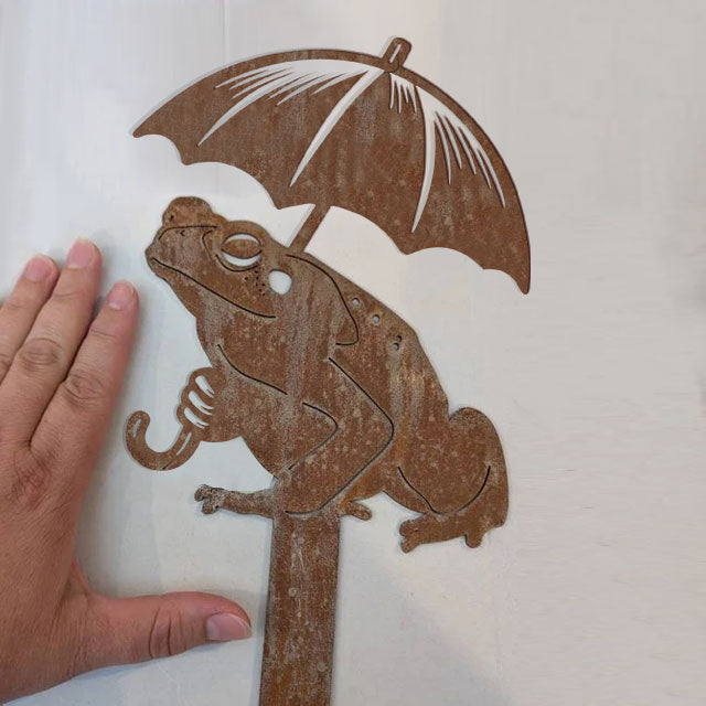 Frog holding an umbrella metal art
