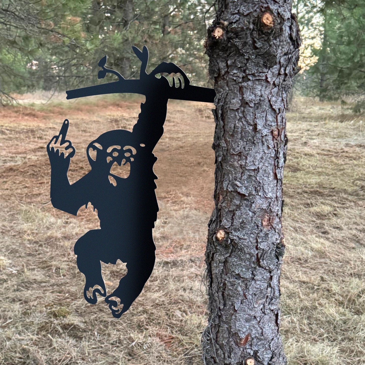 Metal of a monkey with the middle finger raised