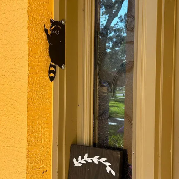 Raccoon giving the middle finger metal art