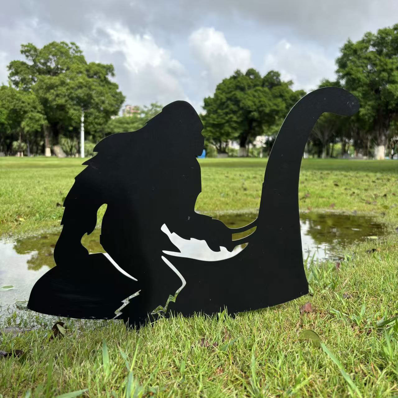 Bigfoot riding Loch Ness Monster metal art
