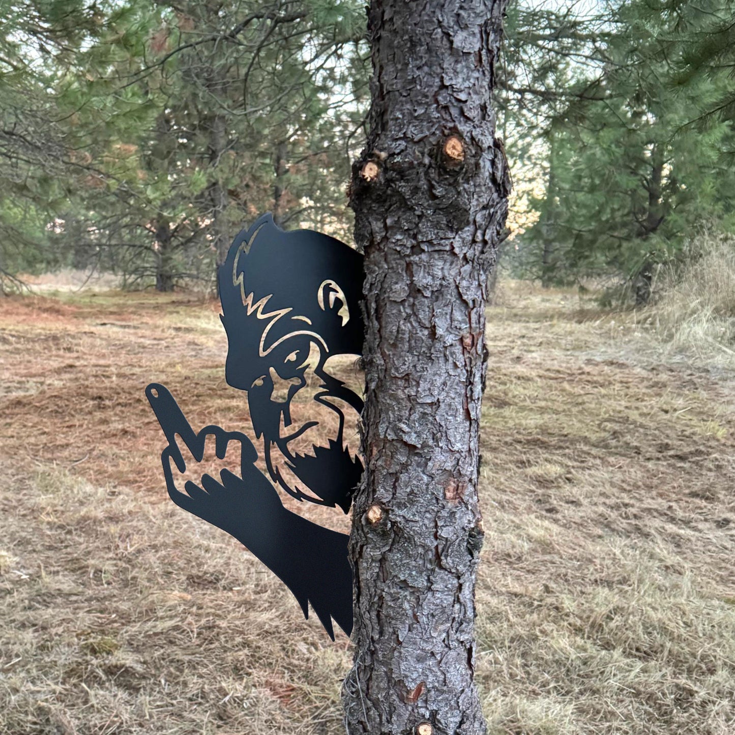 Bigfoot metal art showing middle finger