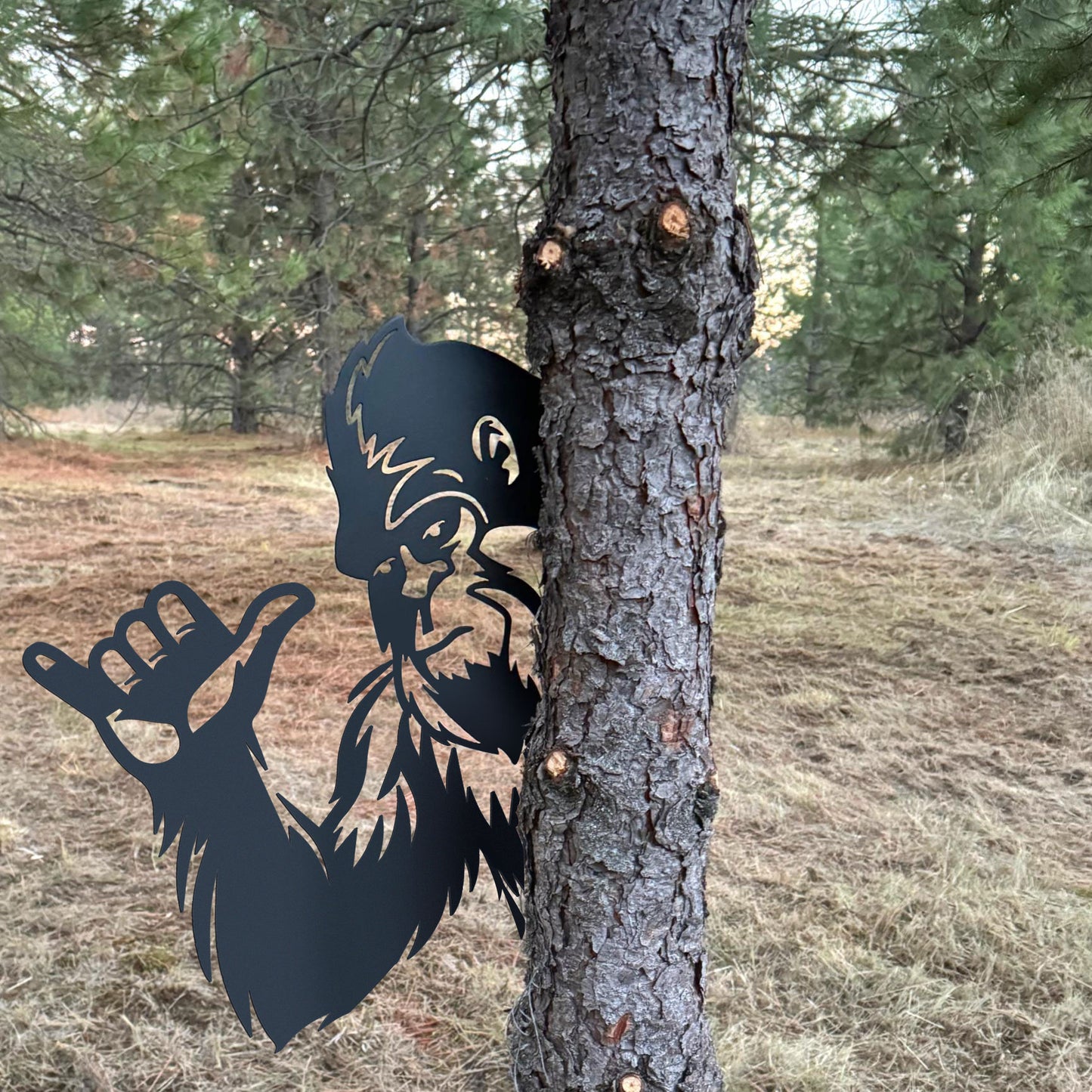 Bigfoot metal art showing middle finger