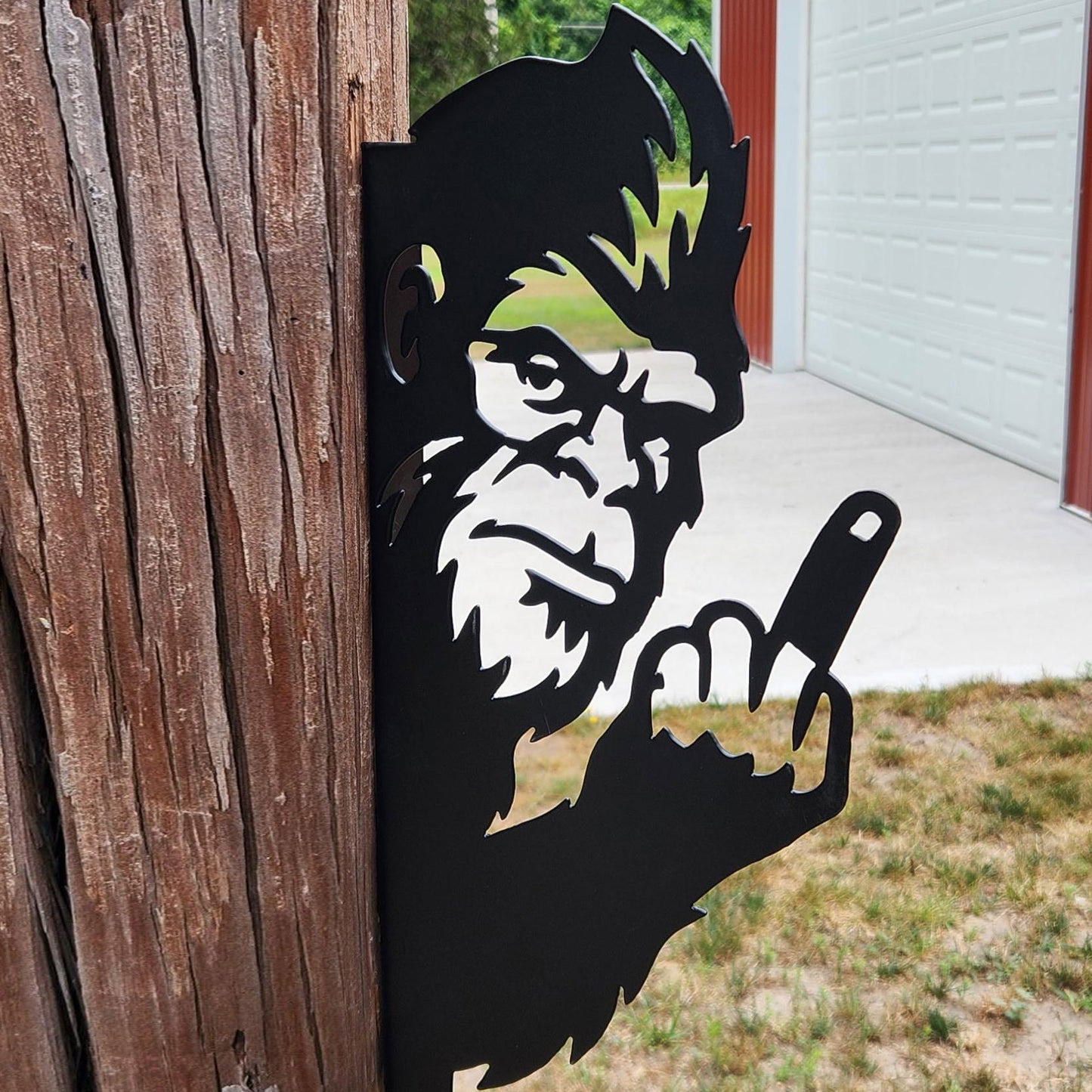 Bigfoot metal art showing middle finger